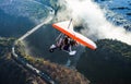 Tourists fly over the Victoria Falls on the trikes. Royalty Free Stock Photo